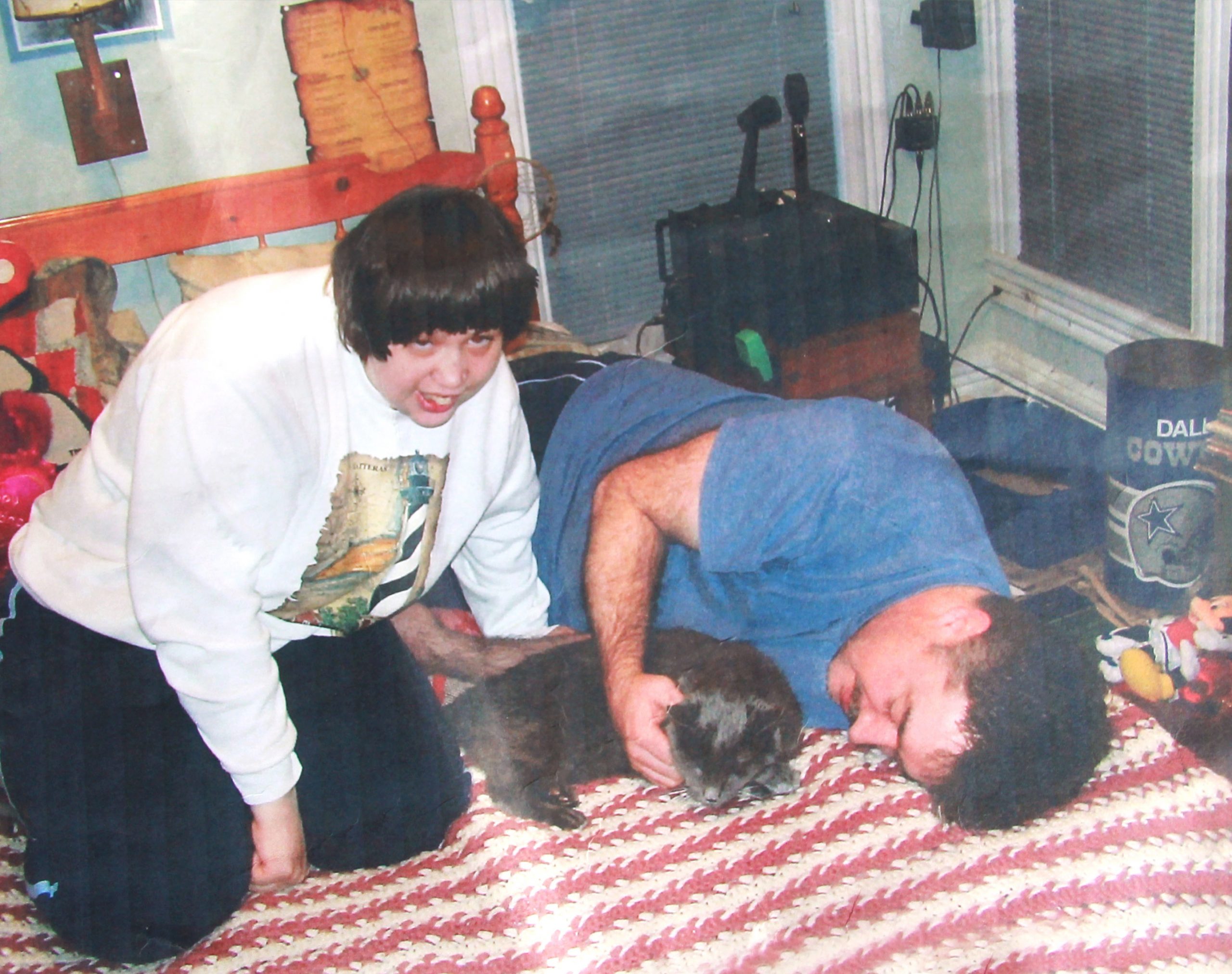 Janet and Chris in their first apartment with their cat, Levi